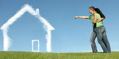 Couple pointing to a cloud in the sky resembling a house